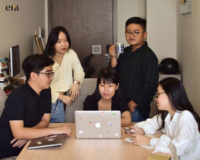 The whole team was reviewing the ongoing projects with the key personnel, Tinh Duong (in a checkered shirt) and Huong Uyen (in a white shirt)